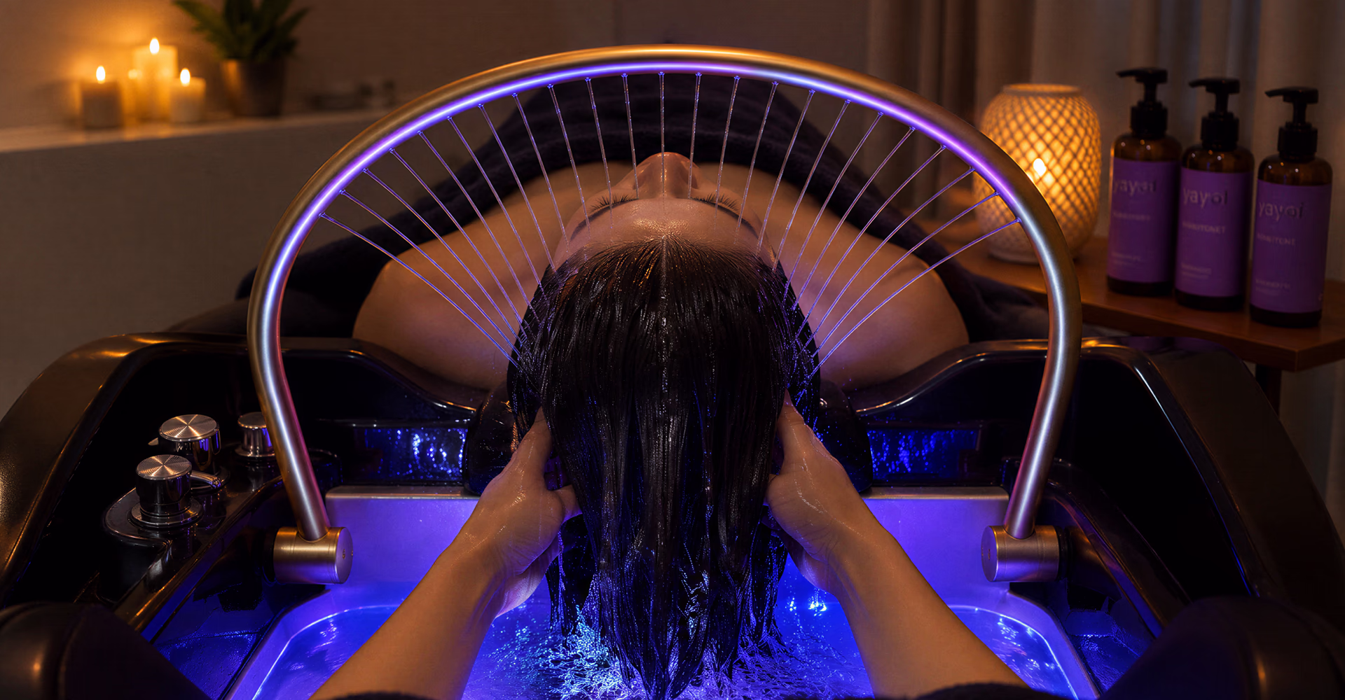 Hair rinsing beneath an illuminated water arch.